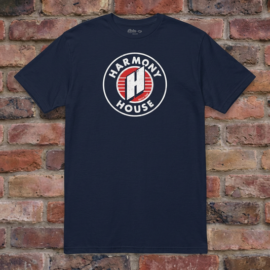 Harmony House Navy T-shirt flat lay on warm brick
