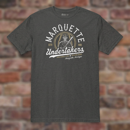 Marquette Undertakers Dark Heather Grey T-shirt flat lay on brick background