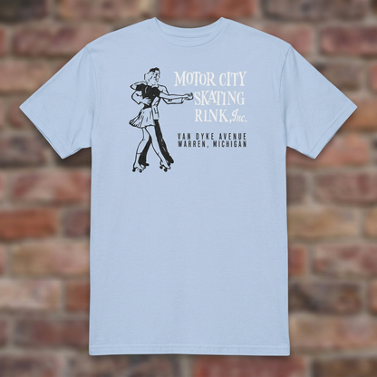 Motor City Skating Rink Light Blue T-shirt flat lay on brick background