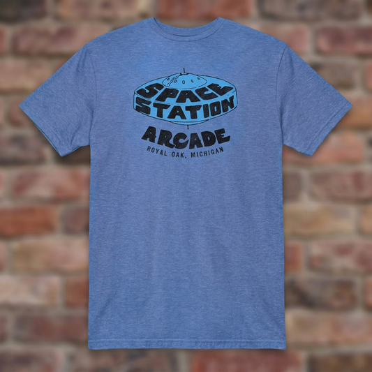 Space Station Arcade Heather Royal T-shirt flat lay on brick background