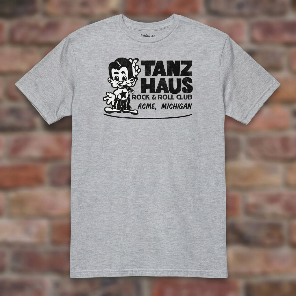 Tanz Haus Sport Grey T-shirt flat lay on warm brick