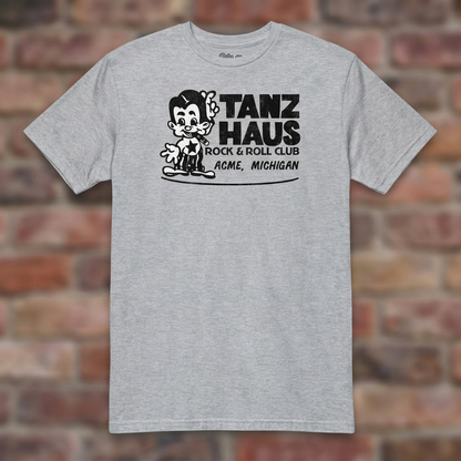 Tanz Haus Sport Grey T-shirt flat lay on warm brick