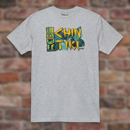 Chin Tiki Sport Grey T-shirt flat lay on brick background