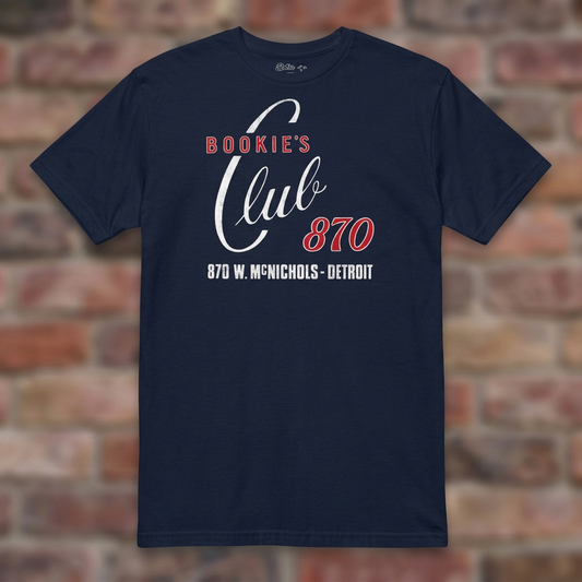 Bookie's Club 870 Detroit T-shirt in Navy, flat lay on warm brick background