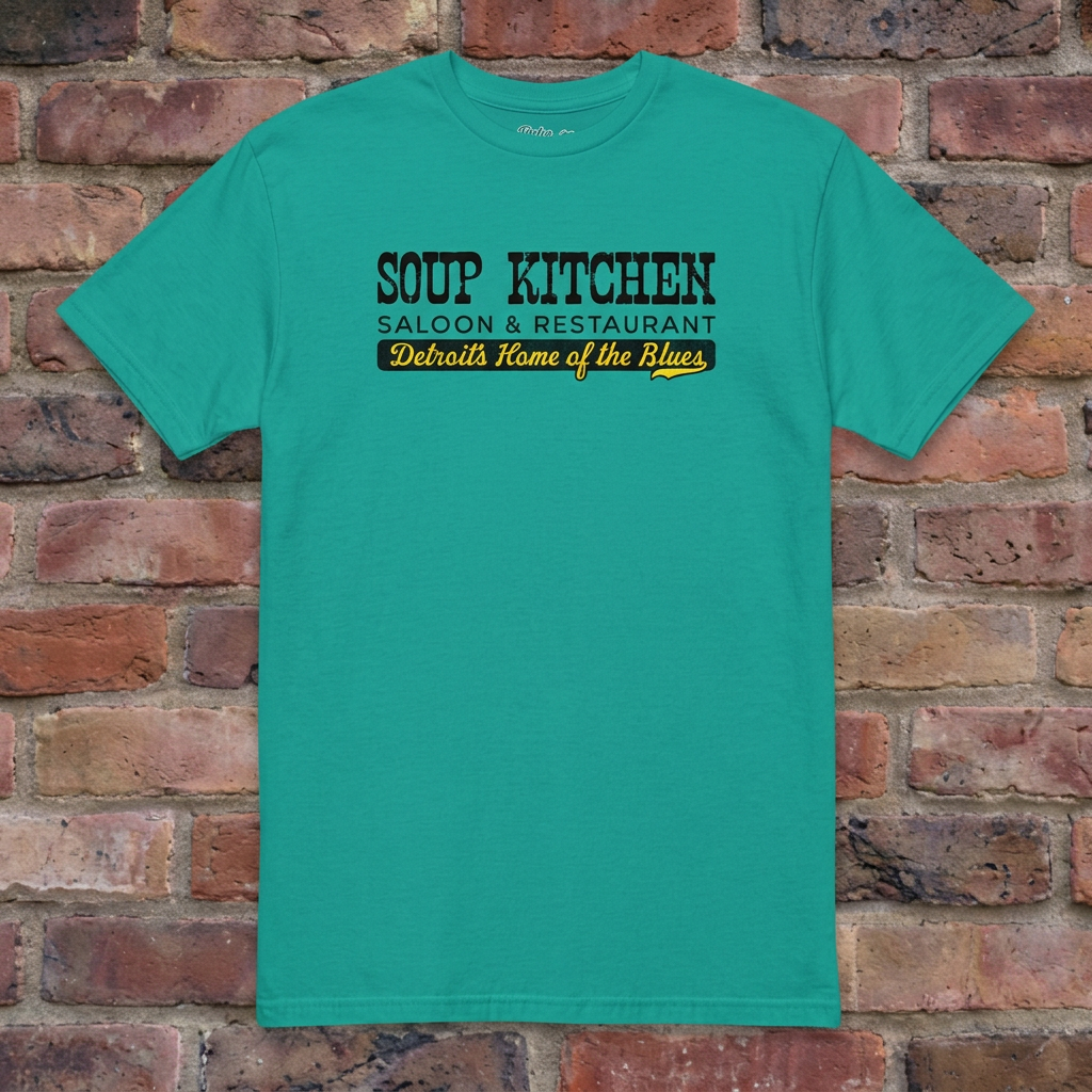 Soup Kitchen Saloon Jade Dome T-shirt flat lay on brick background