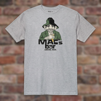 Sport Grey Mac's Bar Lansing T-shirt flat-lay against weathered brick