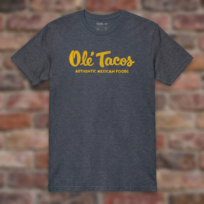 Ole Tacos Heather Navy T-shirt flat lay on brick background