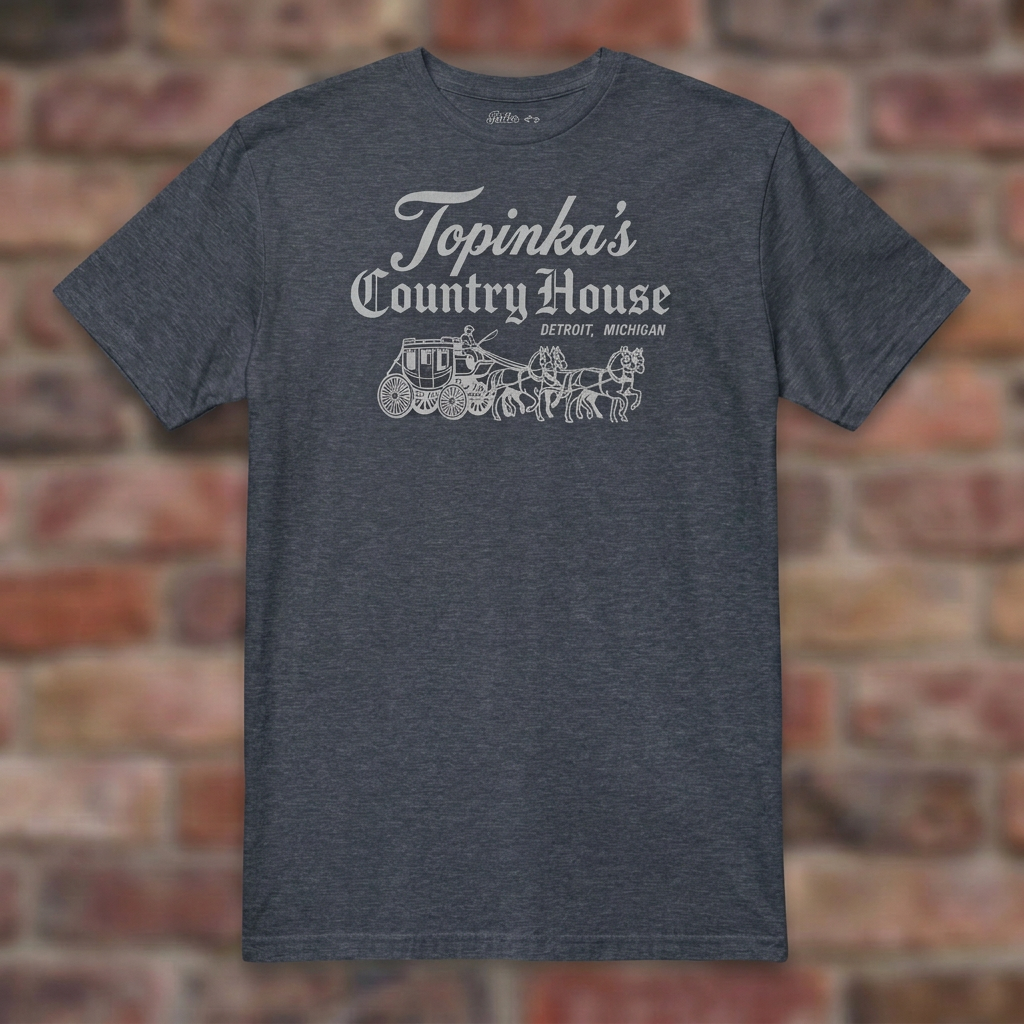 Topinka's Heather Navy T-shirt flat lay on brick background