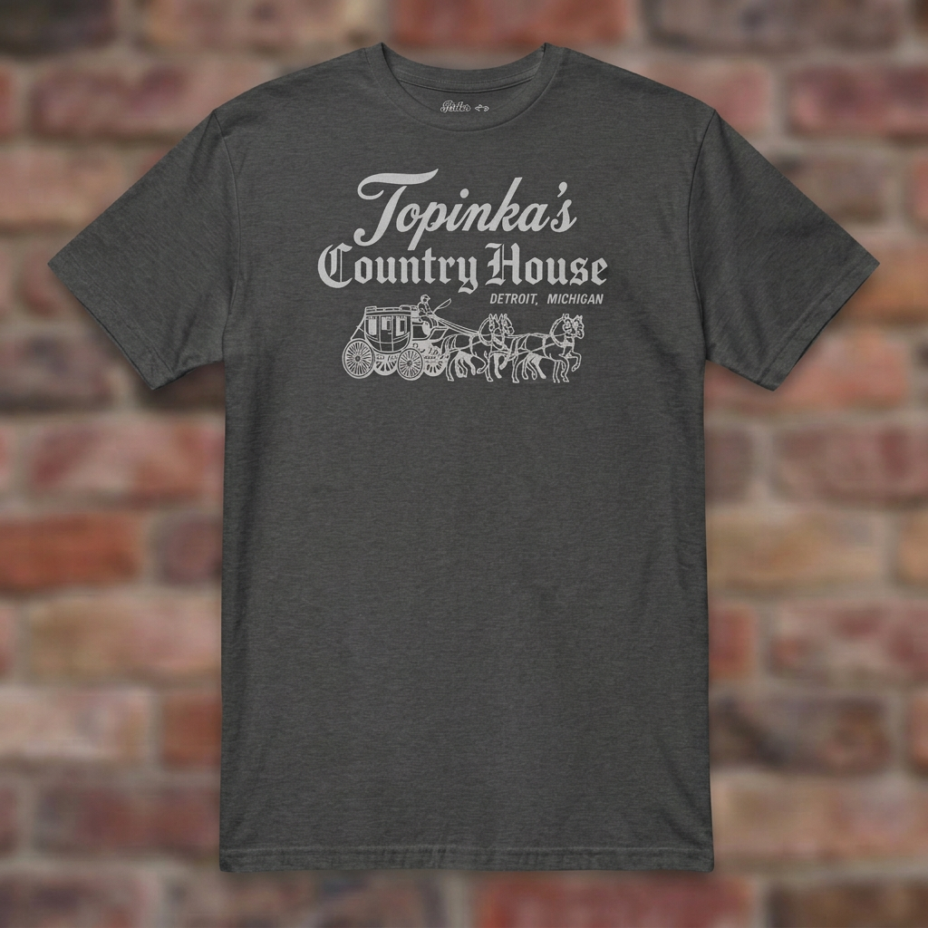 Topinka's Dark Heather Grey T-shirt flat lay on brick background