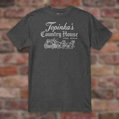 Topinka's Dark Heather Grey T-shirt flat lay on brick background