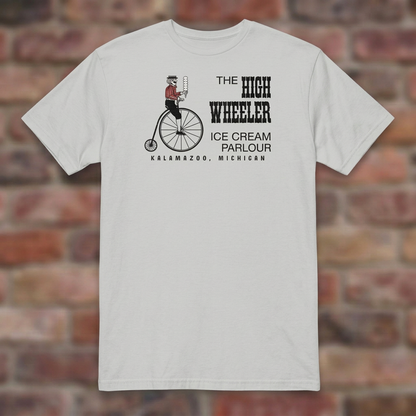 High Wheeler Ice Grey T-shirt flat lay on brick background