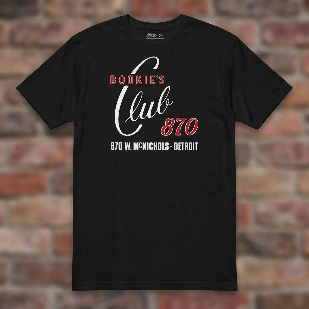 Bookie's Club 870 Detroit T-shirt in Black, flat lay on warm brick background