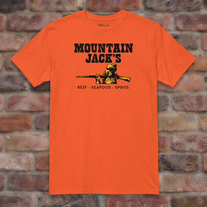 Mountain Jack's Orange T-shirt flat lay on brick background