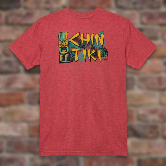 Chin Tiki Heather Red T-shirt flat lay on brick background