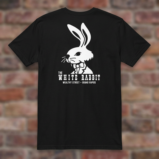 White Rabbit Black T-shirt flat lay on warm brick
