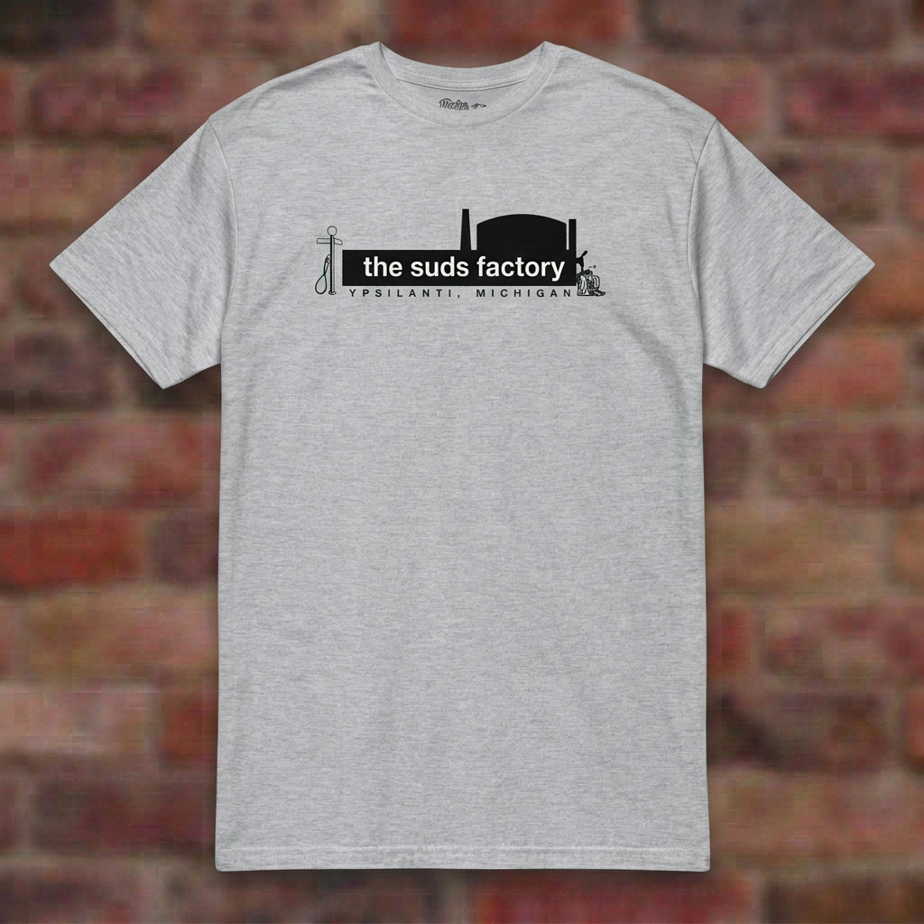 The Suds Factory Sport Grey T-shirt flat lay on brick background