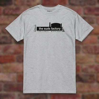 The Suds Factory Sport Grey T-shirt flat lay on brick background