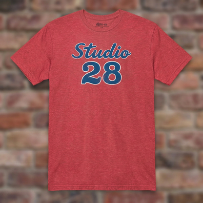Studio 28 Heather Red T-shirt flat lay on brick background