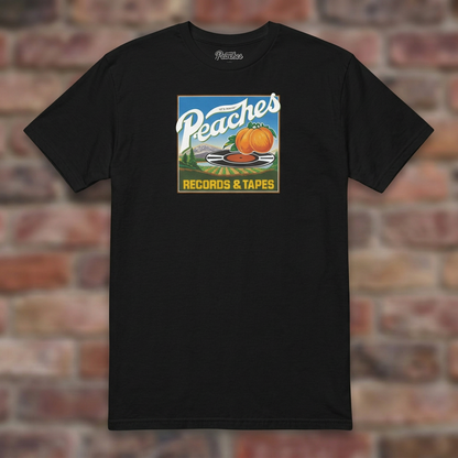 Peaches Records & Tapes Black T-shirt flat lay on brick background