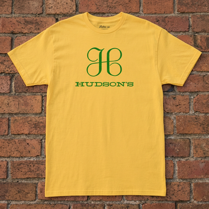 Hudson's Dept Store Detroit T-shirt in Daisy, flat lay on warm brick background