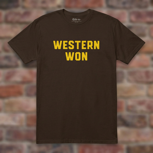 Dark Chocolate Western Won T-shirt flat-lay against weathered brick