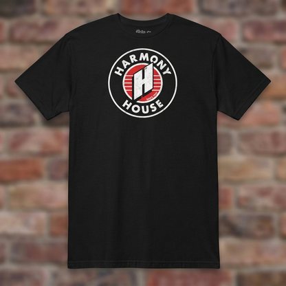 Harmony House Black T-shirt flat lay on warm brick