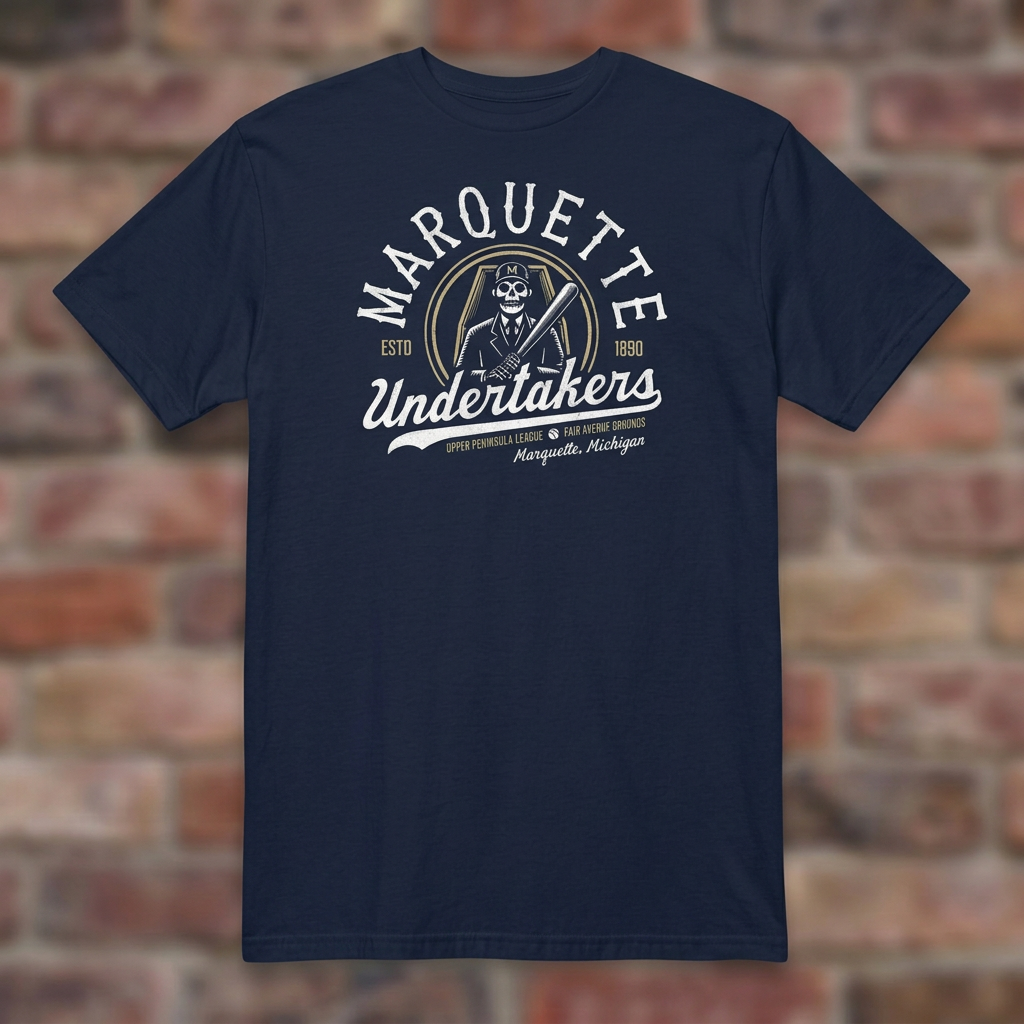 Marquette Undertakers Navy T-shirt flat lay on brick background