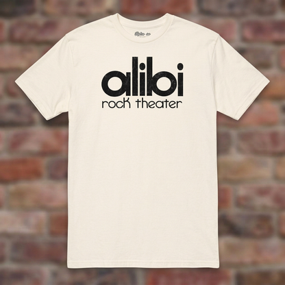 Alibi Rock Theater Natural T-shirt flat lay on brick background