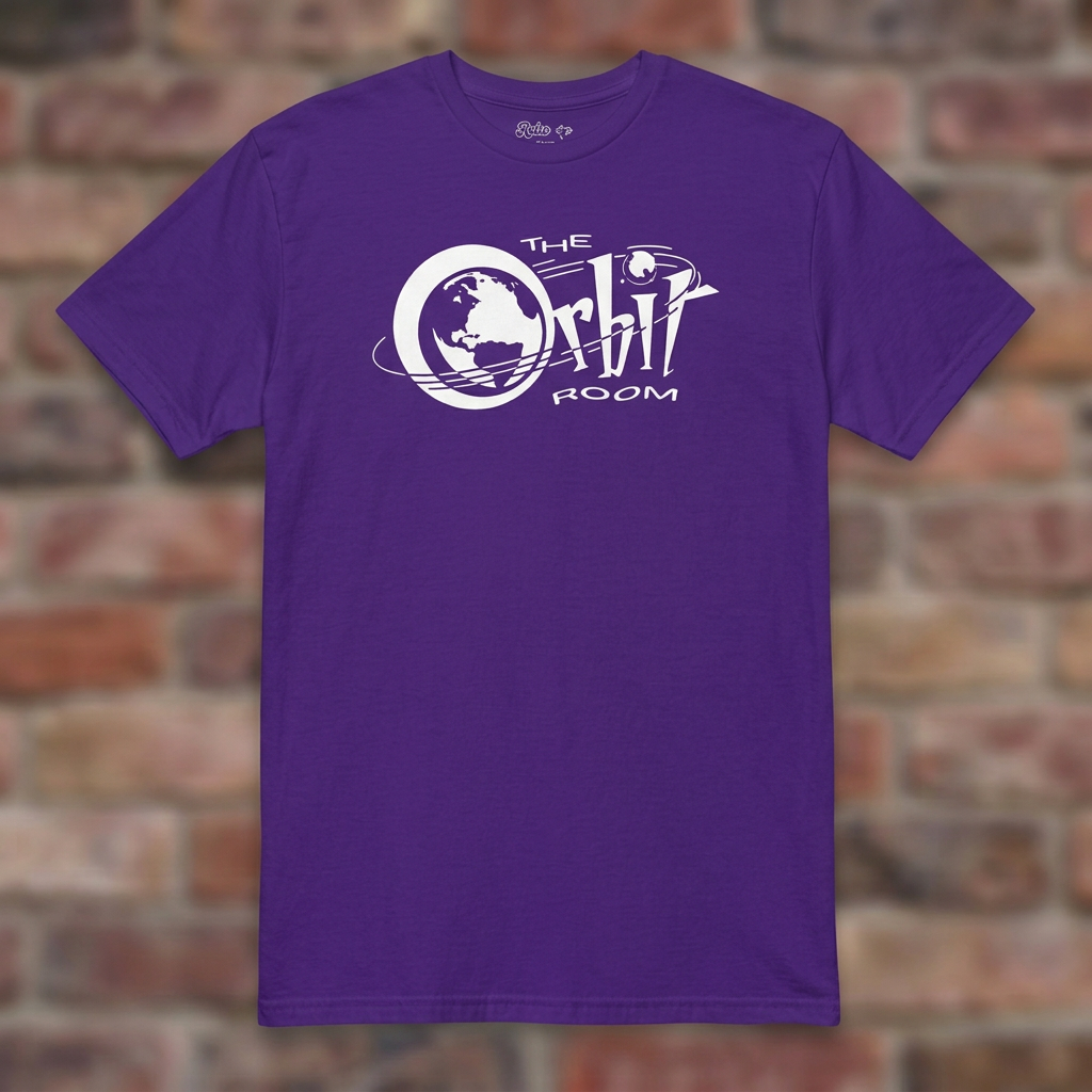 The Orbit Room Purple T-shirt flat lay on weathered brick background