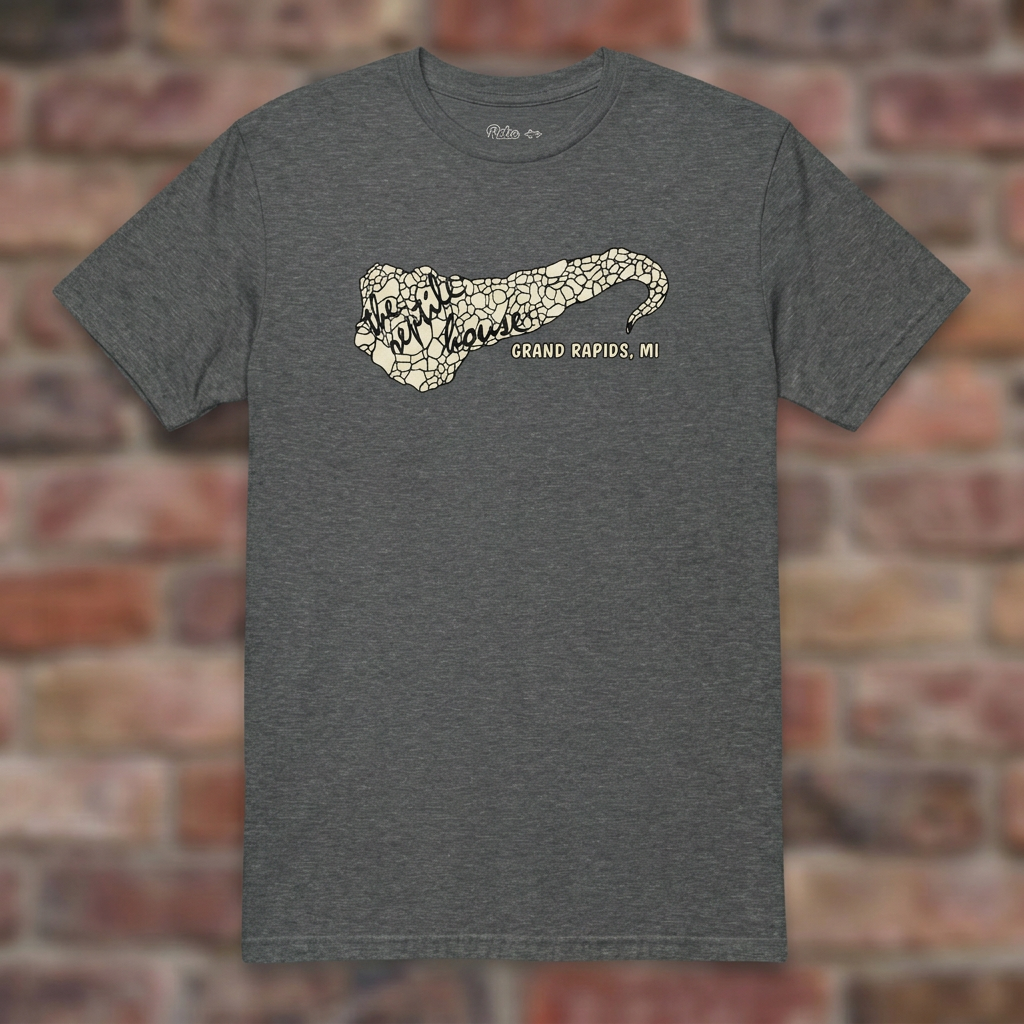 The Reptile House Grand Rapids Graphite Heather T-shirt flat lay on brick background