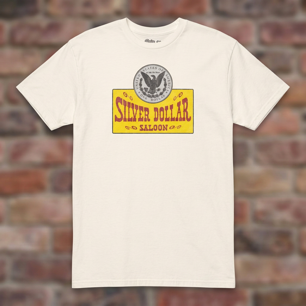Silver Dollar Saloon Natural T-shirt flat lay on warm brick