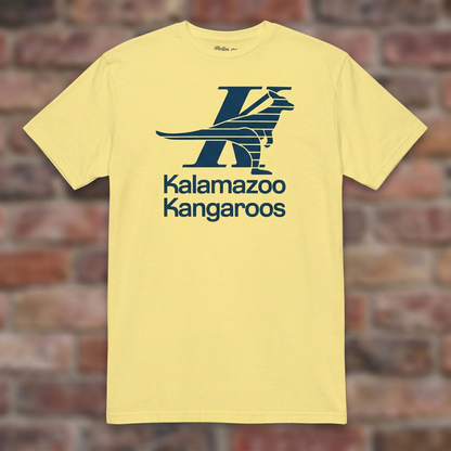 Kalamazoo Kangaroos Cornsilk T-shirt flat lay on brick background