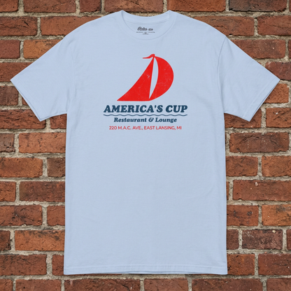 America's Cup Light Blue T-shirt flat lay on brick background