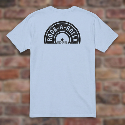 Rock-A-Rolla Records Light Blue T-shirt flat lay on brick background