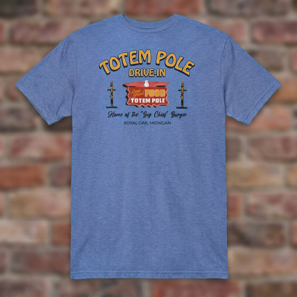 Totem Pole Drive-In Heather Royal T-shirt flat lay on brick background
