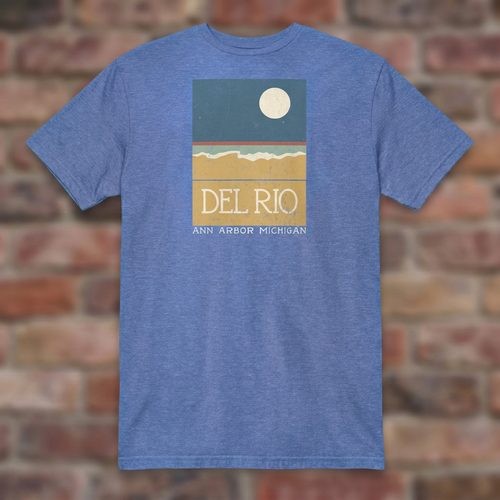 Del Rio Ann Arbor Heather Royal T-shirt flat lay on brick background