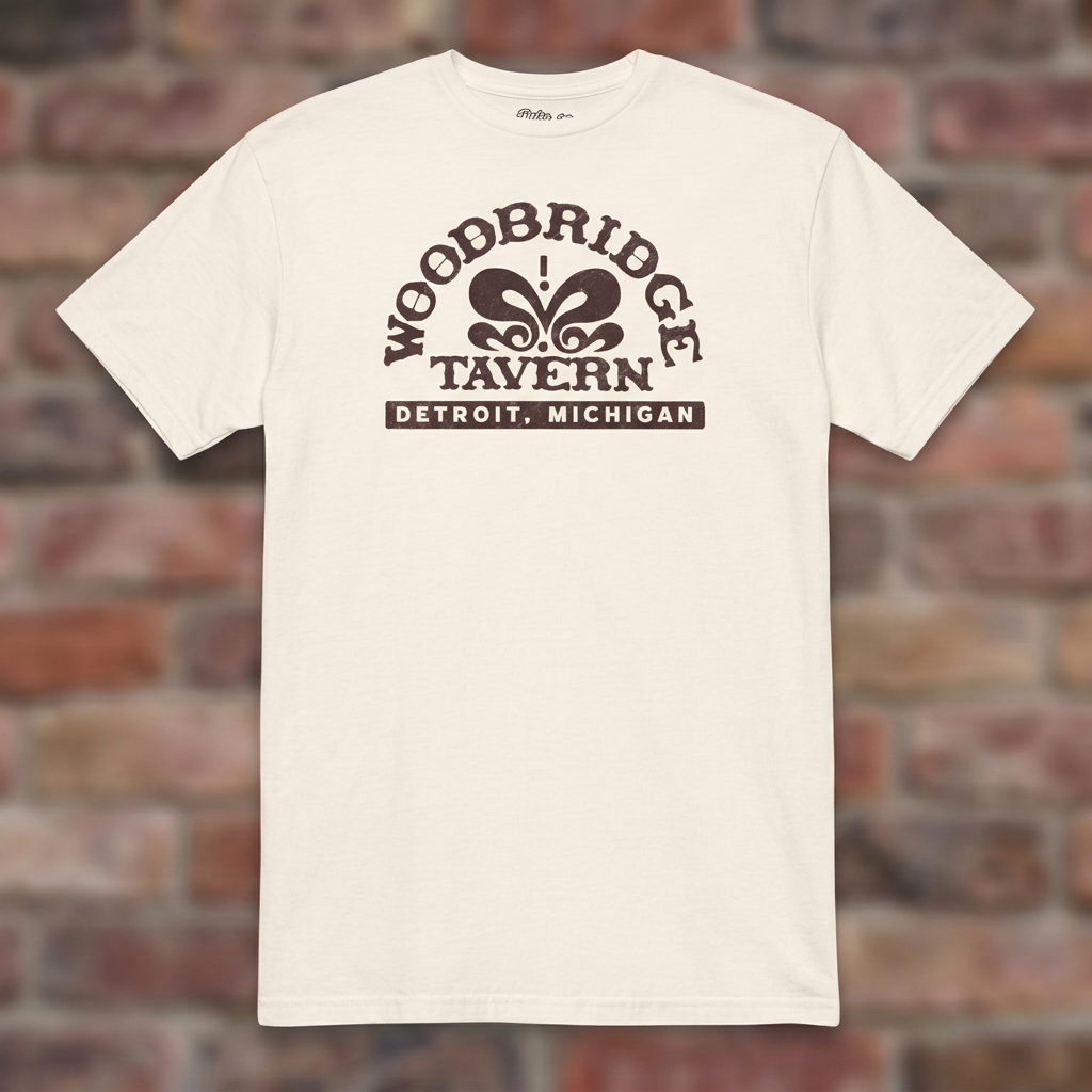 Woodbridge Tavern Natural T-shirt flat lay on brick background