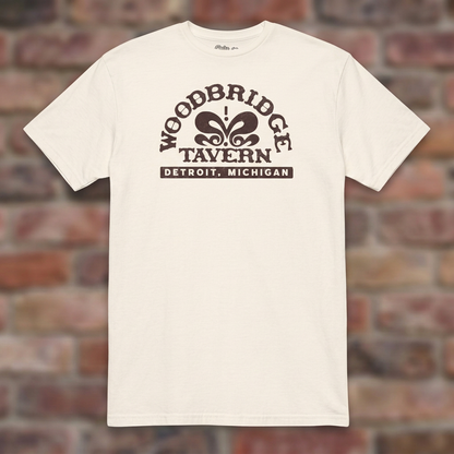 Woodbridge Tavern Natural T-shirt flat lay on brick background