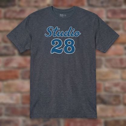 Studio 28 Heather Navy T-shirt flat lay on brick background
