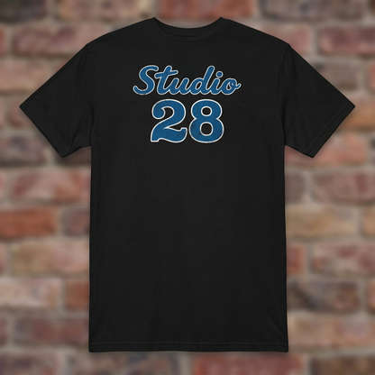 Studio 28 Black T-shirt flat lay on brick background