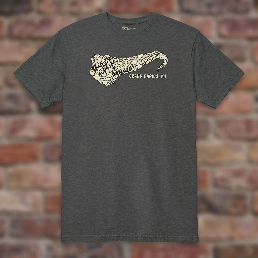 The Reptile House Grand Rapids Dark Heather Grey T-shirt flat lay on brick background