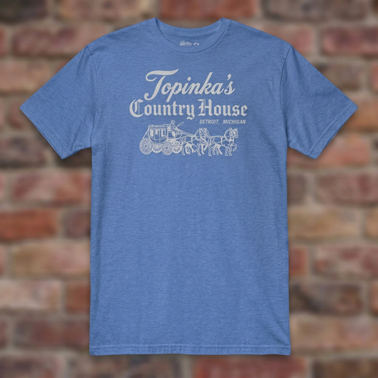 Topinka's Heather Royal T-shirt flat lay on brick background