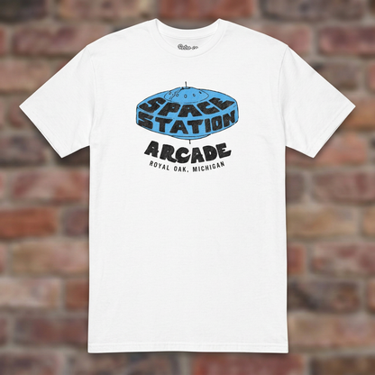 Space Station Arcade White T-shirt flat lay on brick background