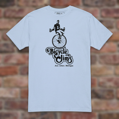 Bicycle Jim's Light Blue T-shirt flat lay on brick background