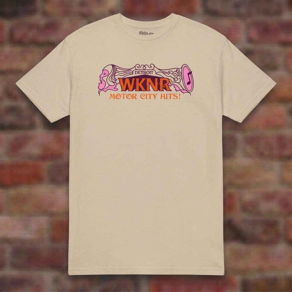 WKNR Radio Sand T-shirt flat lay on brick background