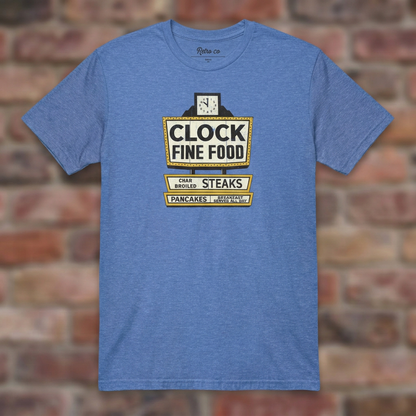 Clock Fine Food Heather Royal T-shirt flat lay on warm brick