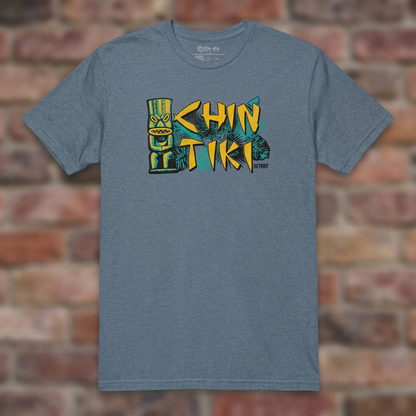 Chin Tiki Heather Indigo T-shirt flat lay on brick background