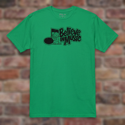 Irish Green Believe in Music T-shirt flat-lay on weathered brick