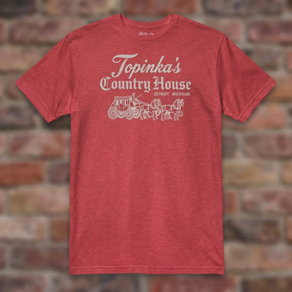 Topinka's Heather Red T-shirt flat lay on brick background