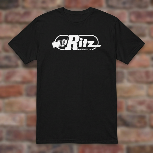 The Ritz Black T-shirt flat lay on brick background